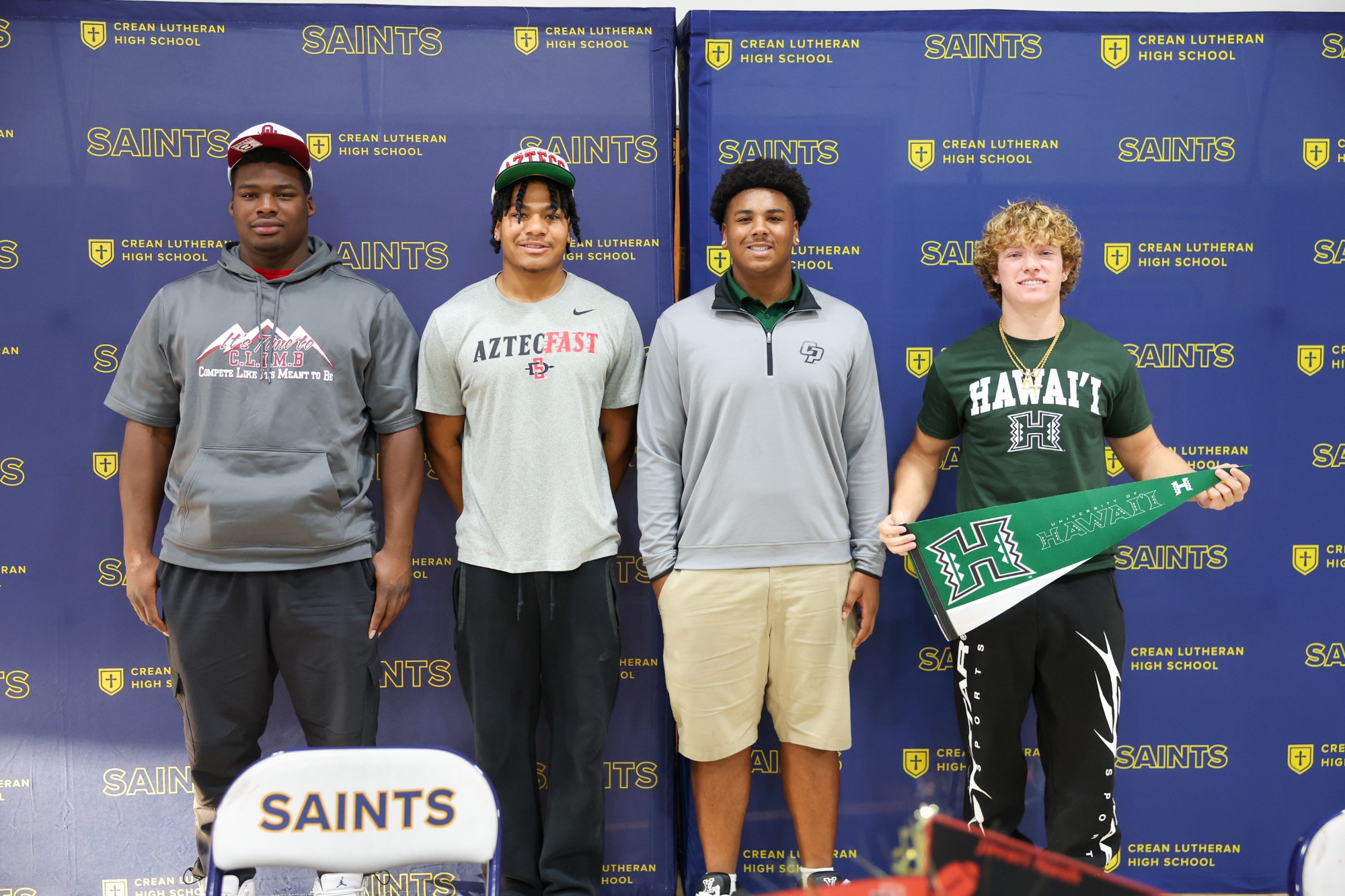 Four Saints Football Players Sign on National Signing Day